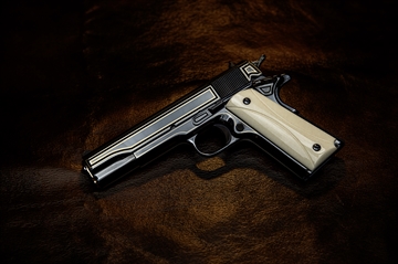 Picture of COLT CLASSIC 1911 RAYMOND J WIELGUS 45 AUTO 5IN BARREL 7RD WIELGUS INSPIRED ENGRAVING AND ROLLMARK POLISHED WITH 24KT GOLD ACCENT INLAY GRIP O1911C-RJW